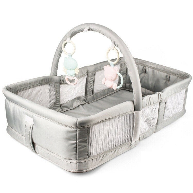portable baby crib attached to bed